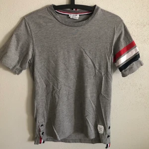 Thom Browne Classic Striped Tee - Women’s Thom Browne Classic Striped T-Shirt  Size small, regular small fit.  Excellent condition, no flaws or damage.  DM if you need exact size measurements.   Buyer pays for all shipping costs. All items sent with tracking number.   No swaps, no trades, no offers. 