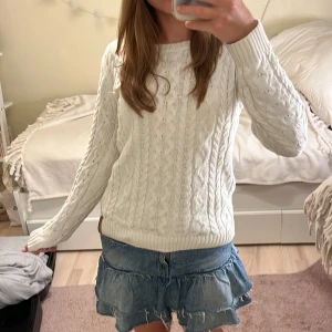 Vit stickad tröja - Säljer en vit stickad tröja från 157 med rund halsringning och långa ärmar. Tröjan har ett klassiskt flätmönster och ribbade muddar vid ärmslut och nederkant.