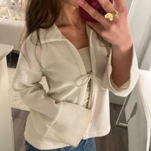  stickad kofta från Gina Tricot - Säljer en superfin stickad kofta från Gina tricot som är väldigt sparsamt använd💗tröjan har super gulligt knyte framtill och ärmarna är super härliga och luftiga🫶 Skriv för fler frågor:)