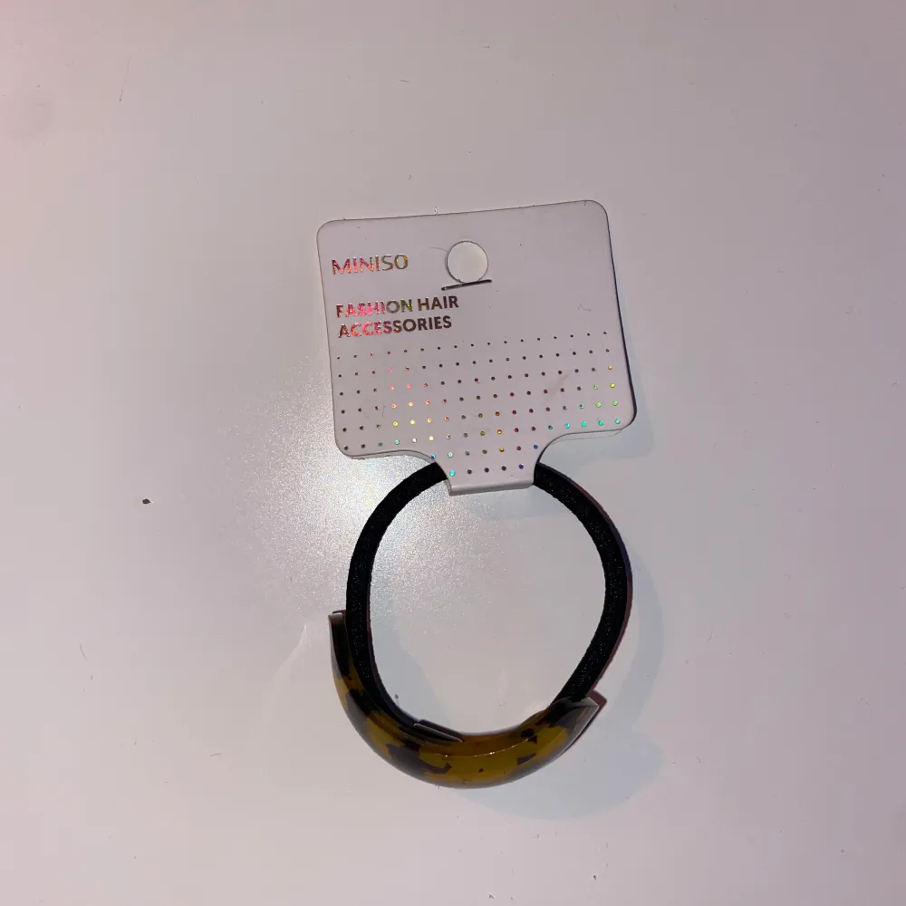 Snygg håraccessoar från Miniso med ett leopardmönstrat plastspänne i bruna och gula toner. Perfekt för att ge en trendig touch till din frisyr.. Asusteet.
