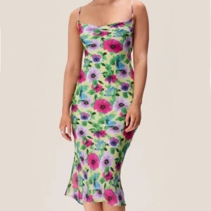 Adoore Vienna dress grön - Superfin långklänning med färgglatt blommönster i rosa, lila, blått och grönt. Klänningen har smala axelband, öppen rygg med knyt och en figurnära passform.