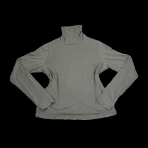 Klädpaket - Grön top med polokrage + matchande grön mössa - Snygg och bekväm långärmad topp i mjukt och stretchigt material från Lindex. Färg: olivgrön/grågrön. Perfekt till både vardag och lager på lager under höst och vinter. Storlek: M Lindex Material: 94% lyocell, 6% elastan ✅Skick: Mycket gott begagnat skick, inga fläckar eller hål.  Stilren och varm mössa i en fin grön färg från Lager 157. Unisex. Perfekt till höst och vinter! Storlek: One size. 🧵Material: 100% akryl. Mjukt och stretchigt material. ✅Skick: I mycket fint skick – knappt använd