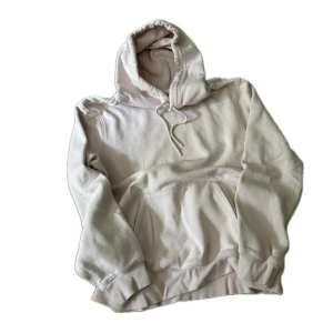 Ljusrosa hoodie från H&M, stl L - Säljer en ljusrosahoodie från H&M i relaxed fit. Tröjan har huva med snörning, magficka och ribbade muddar. 