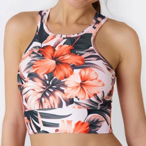 Blommig träningstopp från Stronger XS - Supersnygg croppad träningstopp från Stronger med tropiskt blommigt mönster i rött, rosa, svart och vitt. Hög halsringning och ärmlös design, perfekt för gymmet eller yoga. Sitter tight och har sportig vibe med coola kontrastfärger.