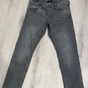 Grå jeansbyxor - Säljer ett par as feta grå jack & jones jeans . Byxorna har en rak passform och normal midja, perfekta för en stilren vardagslook.