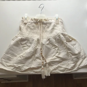 Vit kortkjol med broderier och snören - Säljer min jättefina vita kjol i från zara! Kjolen är i storlek XS men jag brukar ha S och den passar perfekt så den är ganska stor i storleken. Kan diskutera priset!💗