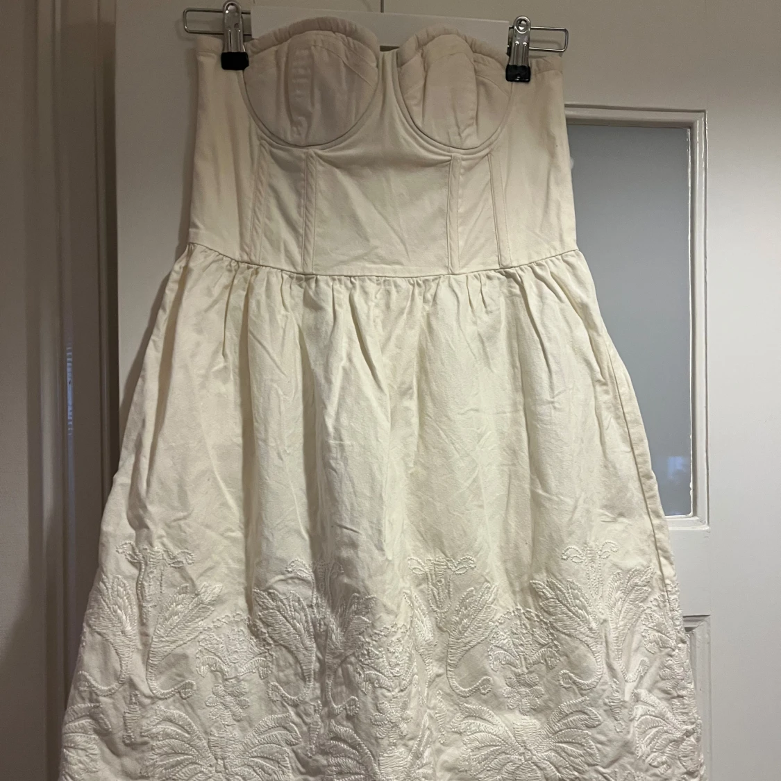 Vit axelbandslös broderad klänning