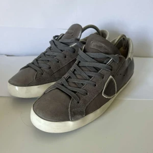 Gråa sneakers med vit sula - Snygga grå sneakers med vit platt sula och rund tå. Skorna har snörning och är tillverkade i skinn, vilket ger en stilren och klassisk look. Perfekta till jeans eller andra avslappnade outfits. Stolek 40 skriv om ni har frågor🔥🔥🔥🔥🔥