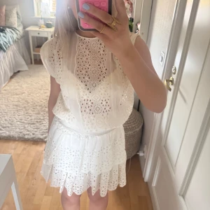 Vit spetsklänning/ studentklänning  - Säljer en söt vit klänning med vackra spetsdetaljer och volanger. Lite mer åt det kräm vita hållet men tycker att den passar superbra som studentklänning!! Står tyvärr ingen storlek i den men skulle säga xs/s