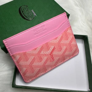 Rosa kortfodral  - Säljer ett snyggt rosa kortfodral. Fodralet har flera fack för kort och en kontrasterande gul insida. Perfekt för att hålla ordning på dina kort med stil.