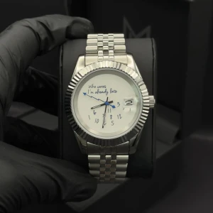 Seiko WHO cares mod - Säljer en unik och stilren klocka i silverfärgat metallarmband och boett. Urtavlan är vit med blå och svarta visare samt texten 'Who cares I'm already late'. Siffrorna är lekfullt utspridda och klockan har datumfönster. Perfekt accessoar för dig med humor!