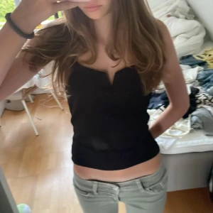 Svart linnetopp med v-ringning - Snygg svart croppad linnetopp med breda axelband och en cool v-ringning i hårt material framtill. Toppen har en enkel och stilren design som är lätt att matcha med jeans eller kjol. Perfekt för en lite festlig topp. Storlek S. Hör av dig om du har frågor eller funderingar 💕