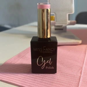 Miss Fancy Gel Polish Old rose - ( skriv till mig innan ni köper) Snygg gel polish från Miss Fancy, använd endast på en finger.  Professional i en ljusrosa nyans. Kommer i en stilren svart fyrkantig flaska med guld- och rosa detaljer på korken. Perfekt för dig som vill ha fräscha och glansiga naglar med en feminin touch.