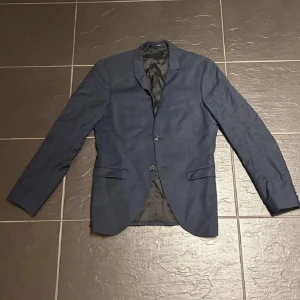 Mörkblå Kavaj Herr - Riktigt stilig kavaj från Tiger of Sweden, använd någon enstaka gång och i grymt skick! Storlek 46, S-M. Skriv vid minsta fundering, mvh!