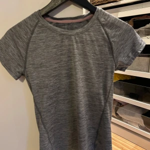 Grön träningst-shirt från Asics - Sportig grön t-shirt från Asics, perfekt för träning. T-shirten har korta ärmar och är tillverkad i ett lätt och funktionellt material som andas. Enkel design med liten Asics-logga på bröstet. Sedna den andra vet jag inte var den är Ifårn men  har inte används så mycket!💞säljer båda för 100 och styck vis 60