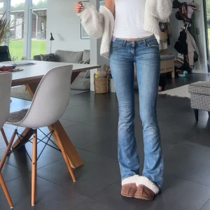 Wrangler bootcut jeans ljusblå - Säljer ett par klassiska blå jeans från Wrangler med bootcut-passform och låg midja. Jeansen har fem fickor, bälteshällor och snygga detaljer på bakfickorna. Perfekta för dig som gillar en tidlös denimlook. Midjemått 36 innerbenslängd 82💞