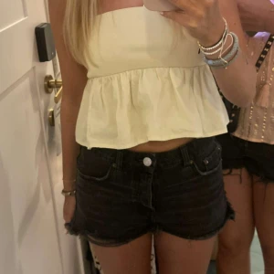 Gul axelbandslös topp - Säljer en söt gul axelbandslös topp med volangdetaljer. Toppen är croppad och har en ribbad överdel som ger en fin passform. Perfekt för sommardagar!