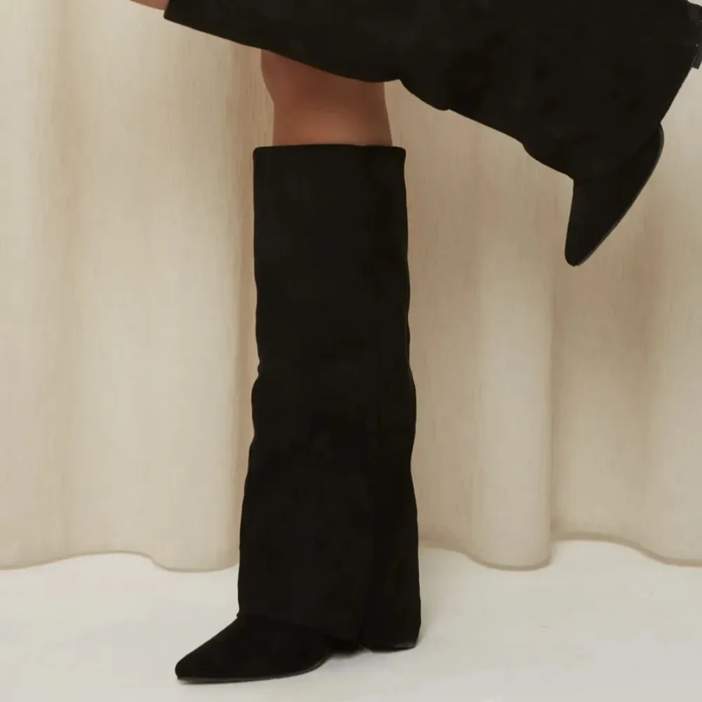 Snygga svarta stövlar med spetsig tå och hög skaft. Perfekta för att ge en stilren look. De är tillverkade i ett elegant material som ger en sofistikerad touch. Köpte från Tyskland för 1000 kr säljer för 550!! Är i bra skick . Kengät.