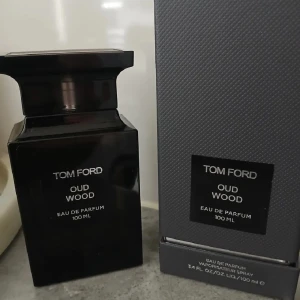 Tom Ford Oud Wood 100 ml parfym - Exklusiv parfym från Tom Ford, Oud Wood, i en svart glasflaska på 100 ml. Cirka 90% kvar. Doften är träig och lyxig, perfekt för dig som gillar unika och djupa doftnoter. Kommer med originalförpackning.