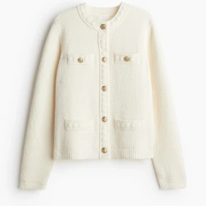 Strukturstickad kofta hm - Säljer en stilren vit kofta med rund hals och dekorativa guldknappar framtill. Koftan har två bröstfickor och två fickor nertill, samt långa ärmar. Perfekt för att lyfta vilken outfit som helst! I storlek xs, nytt skick! 