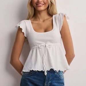 Cute frill tie top - Sååå söt vit sommar top grå Nelly💖bara använt några få gånger o säljer då den inte kommer till användning. Skriv vid frågor 💗