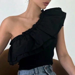 Svart oneshoulder topp med volang - Super fin oandvänd volangtopp, nypris 130kr