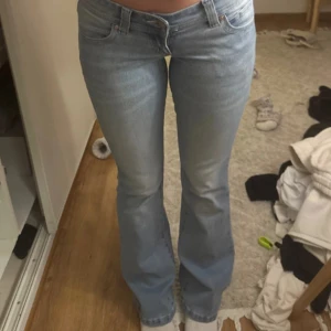 00 super low kick abrand jeans - Säljer ett par ljusblå bootcut jeans från abrand med klassisk femficksdesign och låg midja. Jeansen har en lätt utsvängd passform nertill och är perfekta för en avslappnad stil. Snygga detaljer på bakfickorna.