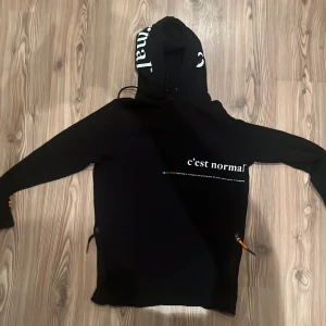 Svart hoodie från C'est Normal - C’est Normal hoodie, svart, strl. S, väldigt bra skick, endast använd ett fåtal ggr.                             Tveka inte att höra av dig för mer detaljer