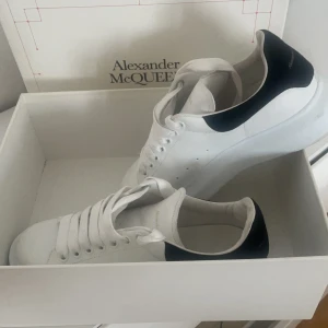 Vita sneakers från Alexander McQueen - Stilrena vita sneakers från Alexander McQueen använda endast fåtal gånger , skorna är i bra skick och är i storlek 39 , skorna är självklart äkta 