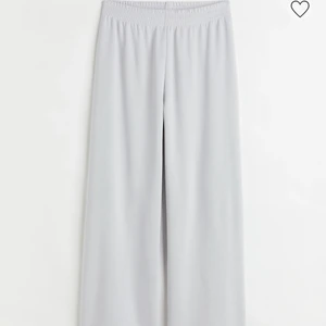 Gråa byxor - Säljer dessa trendiga byxor från H&M i färgen grå som har en normalhög midja med resår samt raka ben. Skulle säga att dessa passar någon som är mellan 159-163cm. Frakten ingår ej i priset. 
