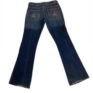 Ascoola lågmidjade bootcut jeans ifrån ” 7 for all mankind ” med sjukt coola rosa detaljer på bakfickan, dom har väldigt små slitningar längst ner på baksidan men annars är dom i väldigt bra skick