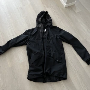 Skidjacka WARP - Svart tunnare skidjacka WARP strl. M. Längre modell. Använd tre veckor. I mycket gott skick! OBS! En ”tagg” i dragkedjan har dock gått av en bit. Inga problem att dra upp, men man behöver hålla jackan sträckt på vägen ner så den inte fastnar där först.