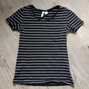 Randig T-shirt - Svart t-shirt med vita ränder från H&M i strl S. 95% bomull 5% elastan.