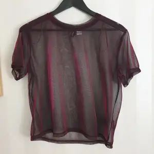 Transparent T-shirt with purple reflections, perfect for wearing over a bikini top. Little traces of use