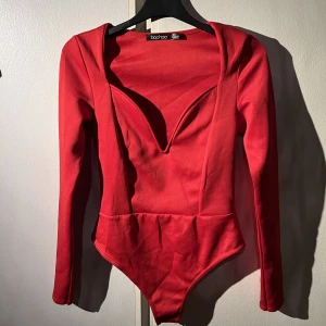 Body  - Röd skitsnygg body från boohoo i stl 34. Köparen står för frakten!