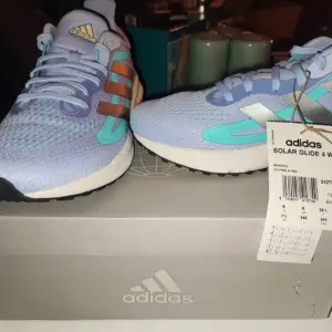 Helt nya äkta adidas sneakers! lila med blåa detaljer. sitter bra och är bekväma på alla sätt. Aldrig använda. Kontakta mig om du har frågor eller vill ha mer info💗