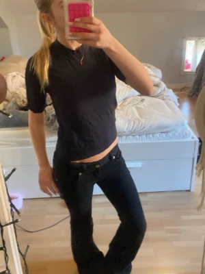 Marinblå stickad kortärmad t-shirt - En enkel marinblå stickad t-shirt med korta ärmar och rund hals. Modellen är figurnära och passar perfekt till jeans eller kjol. Tillverkad i mjukt material som känns skönt mot huden. Aldrig använd tyvärr.