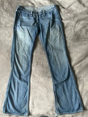 Lågmidjade utsvängda jeans S - Supersnygga lågmidjade jeans, skulle säga S. Skriv för mått! Bra skick förutom slitna längst ned och saknar en bit av dragkedjan men inget som förstör funktionen❤️