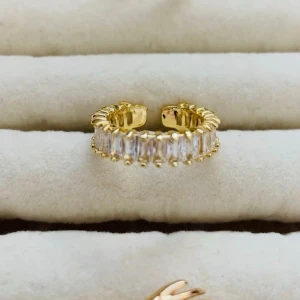 Extra ring på köpet  - Snygg guldfärgad ring med öppningsbar design och rektangulära vita stenar runt hela bandet. Ringen har en modern och lyxig känsla med glittrande detaljer som verkligen sticker ut.