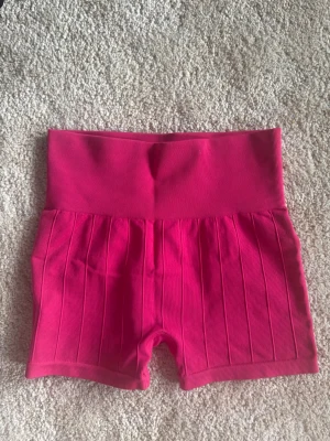 Rosa ribbade högmidjade träningsshorts - Snygga rosa shorts med hög midja och ribbad struktur. Materialet känns stretchigt och bekvämt.