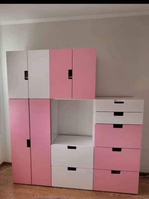 Rosa och vit förvaringshylla - Säljer en stor gaderob modern design med luckor och lådor i rosa och vitt. Gaderoben har flera fack och öppna ytor, perfekt för att organisera prylar eller böcker. Tillverkad i trä eller träliknande material och har svarta handtag på alla luckor och lådor. Ordinarie pris 6000 kr. Kontakta för mer info finns i Borås! 