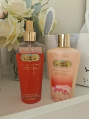 Victoria's Secret Pure Daydream set - Säljer ett set med Victoria's Secret Pure Daydream, innehållande en body mist (250 ml) och en återfuktande body lotion (236 ml). Doften har inslag av pärlorkidé och pink currant. Flaskorna har guldiga lock och rosa toner. Knappt använda. Säljer nu av min vintage kollektion. Perfekt för samlare. Eftersom dofterna är vintage kan lukten skilja sig markant från nya, och köps därmed på eget bevåg.