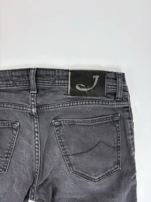 Svarta skinny jeans från Jacob Cohën - Snygga svarta skinny jeans från Jacob Cohën med klassisk femficksdesign och diskret logga på bakfickan. Jeansen har en smal passform och är tillverkade i stretchigt denimtyg för extra komfort.