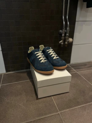 Maison margiela skor - Skorna är i nyskick och säljs med box.              Dem är självklart äkta och har verifierat de. Strl 42 och färg heter deep blue.              Postar in 24h 📩 // mvh ceasar 