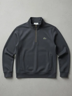 Mörkgrå ziptröja från Lacoste - Snygg mörkgrå långärmad ziptröja från Lacoste med klassisk krokodillogga på bröstet. Tröjan har halv dragkedja och ståkrage, perfekt för en avslappnad men stilren look. Tillverkad i mjukt material för extra komfort.