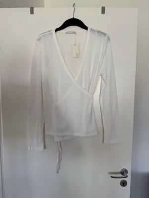 Topp med knytning vit  - Storlek XL. Aldrig använd. Köpt i butik så kan finnas skavanker. 