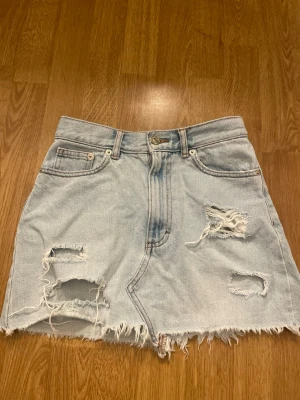Ljusblå jeanskjol - Säljer en snygg ljusblå jeanskjol med slitningar. Kjolen är från Pull & Bear och är i storlek S💙