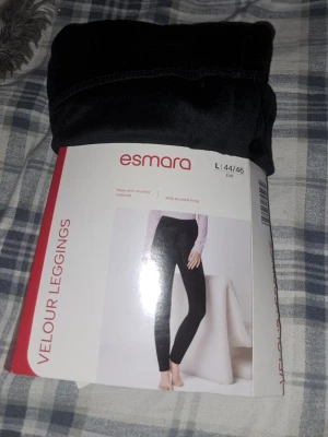 Svarta velourleggings från Esmara - Snygga svarta velourleggings från Esmara i storlek L (44/46). Tillverkade av mjukt material med borstad insida för extra komfort. Perfekta för dig som vill ha både stil och bekvämlighet. Passar till många olika outfits.