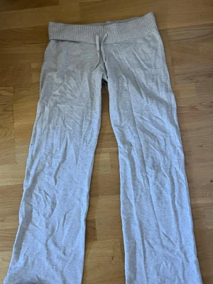 stickade beiga mjukisbyxor från Gina Young  - Säljer ett par beiga mjukisbyxor med bred ribbad midja och dragsko. Byxorna har utsvängda ben och är gjorda i ett mjukt och bekvämt material, perfekt för chill dagar. Jätteskönt material! Passar folk under 163 i längd.