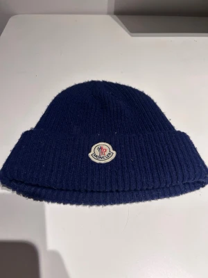  Moncler mössa  - Säljer en mörkblå mössa från moncler. Bra passform och väldigt bra skick. Skick: 9/10👌